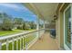 Covered front porch with white railings and neighborhood view at 1068 Blockade Runner Pkwy, Summerville, SC 29485