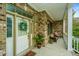 Front porch with white door, potted plant, and seating area at 1068 Blockade Runner Pkwy, Summerville, SC 29485