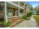 Brick stairs leading up to a charming front porch with white railings at 1068 Blockade Runner Pkwy, Summerville, SC 29485