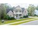 Brick two-story home with a wrap-around porch and landscaped yard at 1068 Blockade Runner Pkwy, Summerville, SC 29485