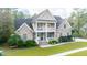 Brick two-story home with a wrap-around porch and landscaped yard at 1068 Blockade Runner Pkwy, Summerville, SC 29485