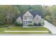 Brick two-story home with a wrap-around porch and landscaped yard at 1068 Blockade Runner Pkwy, Summerville, SC 29485