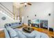 Living room with hardwood floors, sectional sofa, and large TV at 1068 Blockade Runner Pkwy, Summerville, SC 29485
