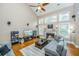 Open living room with hardwood floors, sectional sofa, and built-in shelving at 1068 Blockade Runner Pkwy, Summerville, SC 29485