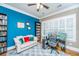 Home office with blue accent wall, built-in shelving, and comfortable seating at 1068 Blockade Runner Pkwy, Summerville, SC 29485
