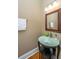 Elegant powder room with glass sink and dark vanity at 1068 Blockade Runner Pkwy, Summerville, SC 29485