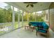 Relaxing screened porch with comfy seating and ceiling fan at 1068 Blockade Runner Pkwy, Summerville, SC 29485