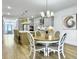 Bright dining area with a round table and four chairs, adjacent to the kitchen at 1115 Saltwater Cir, Johns Island,  29455