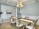 Elegant dining room with a large wood table and globe chandelier at 1115 Saltwater Cir, Johns Island,  29455