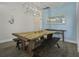 Bright dining room with a live-edge wood table, benches, and a modern chandelier at 1187 Landau Ln, Mount Pleasant,  29466