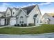 Two-story townhome with gray siding, landscaped lawn, and attached garage at 129 Buchanan Cir, Goose Creek, SC 29445