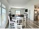 Bright dining area with a round table and chairs, overlooking the living room and kitchen at 148 Camellia Bloom Dr, Moncks Corner, SC 29461