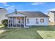 White house exterior with a screened porch and large backyard at 185 Southport Dr, Summerville, SC 29483