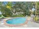 Inviting kidney-shaped pool surrounded by lush landscaping and patio furniture at 19 23Rd Ave, Isle of Palms, SC 29451