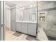 Modern bathroom with double vanity, gray tile, and a walk-in shower at 193 Corn Planters St, Charleston, SC 29492