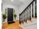 Bright entryway with hardwood floors, black door, and a staircase at 193 Corn Planters St, Charleston, SC 29492