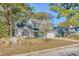 Two-story house with gray siding, double-car garage, and well-maintained lawn at 1965 Oak Tree Ln, Mount Pleasant, SC 29464