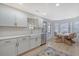 White kitchen with farmhouse sink, gold faucet, quartz countertops, and subway tile backsplash at 1965 Oak Tree Ln, Mount Pleasant, SC 29464