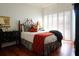 Well-lit bedroom with a queen bed and hardwood floors at 221 S Plaza Ct # 107, Mount Pleasant, SC 29464