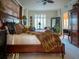 Main bedroom with king-size bed, plush bedding, and a ceiling fan at 221 S Plaza Ct # 107, Mount Pleasant, SC 29464