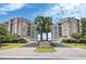 Elegant condo building entrance with palm trees and landscaping at 221 S Plaza Ct # 107, Mount Pleasant, SC 29464
