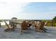 Relaxing fire pit area with wooden chairs overlooking the water at 2584 Helmsman Rd, Johns Island, SC 29455