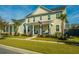 Two-story home with front porch and palm trees in neighborhood at 306 Ripple Park Dr, Summerville, SC 29486