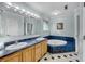 Bathroom with double vanity and jetted tub at 317 W Hudson Ave, Folly Beach, SC 29439
