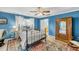 Cozy bedroom with iron bed frame and blue walls at 317 W Hudson Ave, Folly Beach, SC 29439
