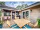 Deck with screened porch, outdoor dining set, and built-in grill at 317 W Hudson Ave, Folly Beach, SC 29439