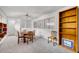 Room features built-in bookshelves, a round wooden table, and additional seating at 317 W Hudson Ave, Folly Beach, SC 29439