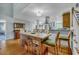 Open concept dining area with a rustic wooden island and kitchen views at 317 W Hudson Ave, Folly Beach, SC 29439