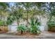 Two-story home with attached two-car garage and lush landscaping at 317 W Hudson Ave, Folly Beach, SC 29439