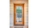 Wooden front door with glass panels and brass door hardware at 317 W Hudson Ave, Folly Beach, SC 29439