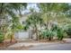 Two-story home with attached garage and tropical landscaping at 317 W Hudson Ave, Folly Beach, SC 29439