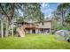 Two-story house, large deck, detached greenhouse, and grassy backyard at 317 W Hudson Ave, Folly Beach, SC 29439