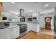 Modern kitchen with stainless steel appliances and white cabinets at 317 W Hudson Ave, Folly Beach, SC 29439
