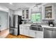 Updated kitchen with stainless steel appliances and white cabinets at 317 W Hudson Ave, Folly Beach, SC 29439