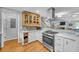 Updated kitchen featuring stainless steel appliances and white cabinets at 317 W Hudson Ave, Folly Beach, SC 29439