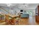 Open living room with vaulted ceiling, fireplace, and access to a deck at 317 W Hudson Ave, Folly Beach, SC 29439