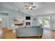 Spacious living area with fireplace, hardwood floors and access to a deck at 317 W Hudson Ave, Folly Beach, SC 29439