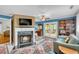Living room with fireplace and access to a private deck at 317 W Hudson Ave, Folly Beach, SC 29439