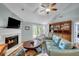 Comfortable living room with a fireplace, hardwood floors, and access to a deck at 317 W Hudson Ave, Folly Beach, SC 29439