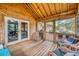 Spacious screened porch with wooden floors and comfortable wicker chairs at 317 W Hudson Ave, Folly Beach, SC 29439