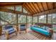 Relaxing screened porch with a swinging daybed and wicker seating at 317 W Hudson Ave, Folly Beach, SC 29439