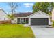 White single story house with dark gray garage door and well-manicured lawn at 325 Parish Parc Dr, Summerville, SC 29485