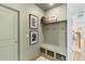 Functional mudroom with built-in bench, storage, and a calming green palette at 4312 Cotton Flat Rd, Summerville, SC 29485