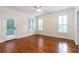 Bright bedroom featuring hardwood floors, plantation shutters, and access to a private deck at 5096 Coral Reef Dr, Johns Island, SC 29455