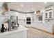 Spacious kitchen boasts white cabinets, stainless steel appliances, and quartz countertops at 5208 Holly Forest, Hollywood, SC 29449