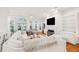 Open living room with a white sectional sofa, fireplace, built-in shelving, and hardwood floors at 5208 Holly Forest, Hollywood,  29449